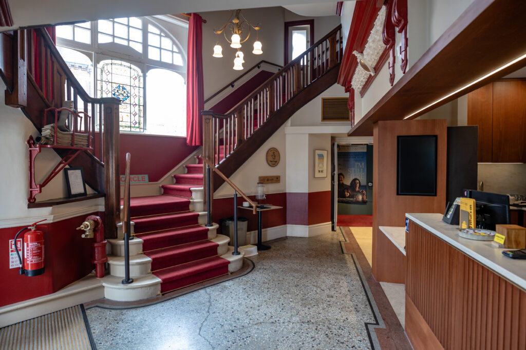 Stairs that have colour contrast, solid closed risers, handrails both sides and flat landings top and bottom.